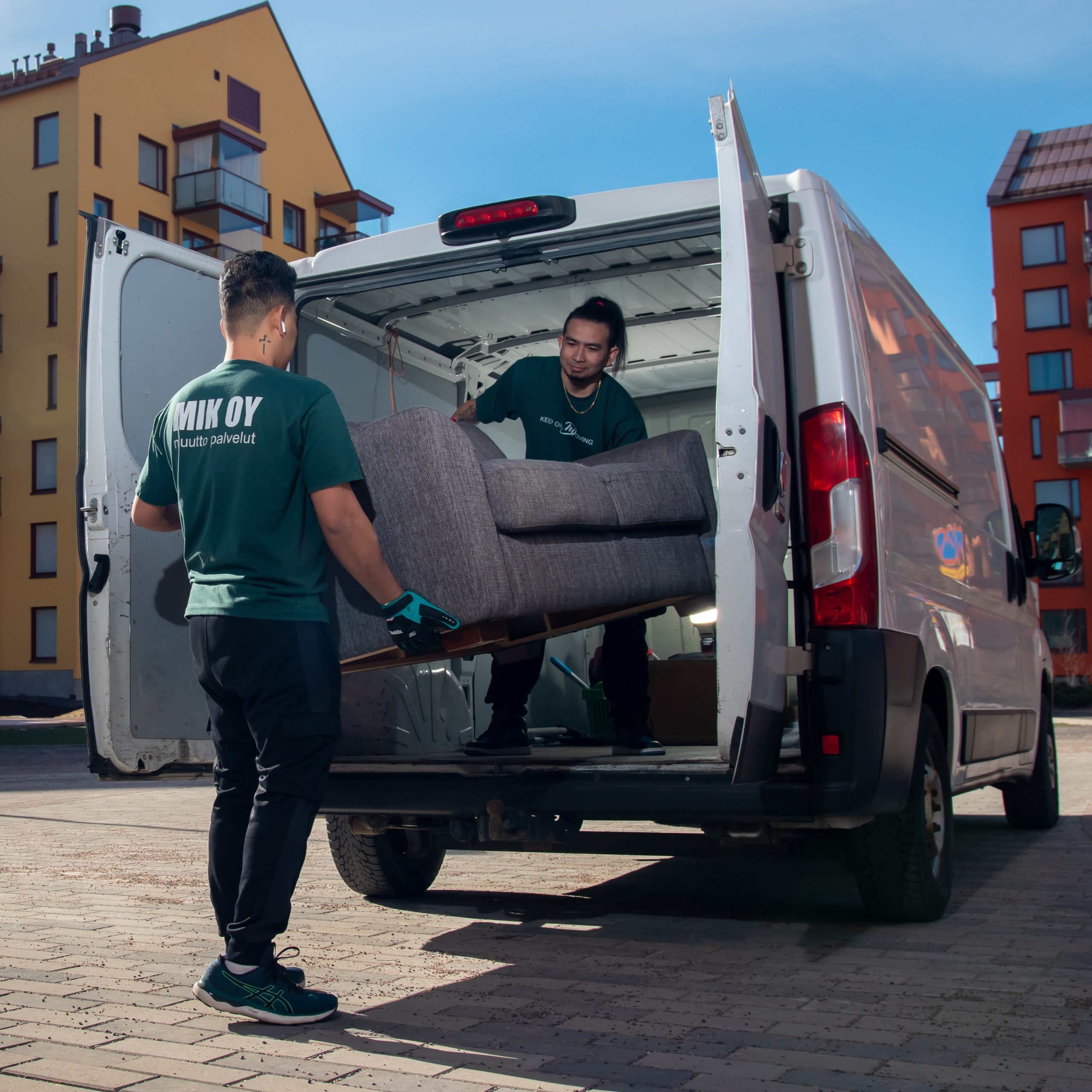 Mik Oy delivery truck with driver loading boxes for local deliveries in Helsinki, Espoo, Vantaa, and Lahti
