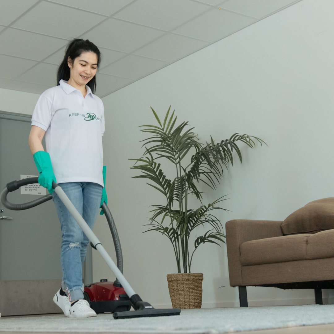 Mik Oy professional cleaner vacuuming office carpet during a scheduled commercial cleaning service in Vantaa, Finland