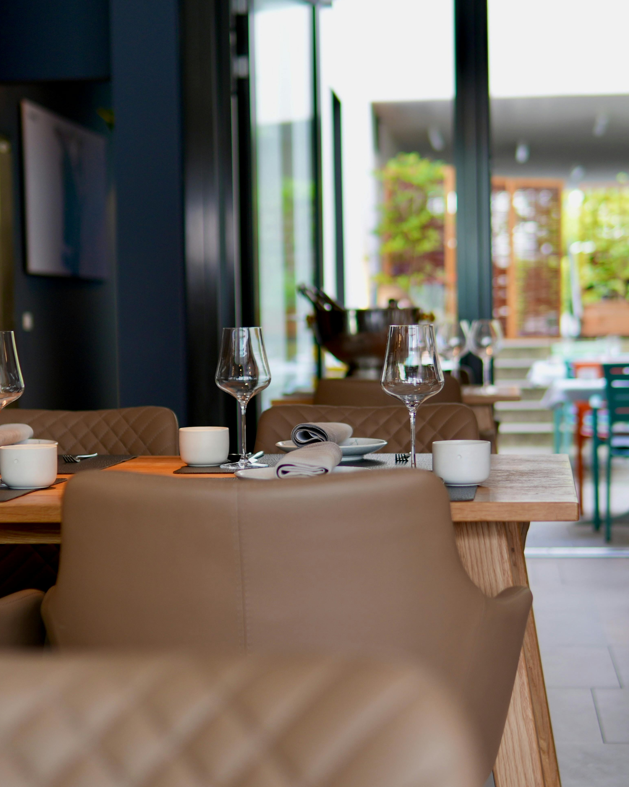 Spotless restaurant dining room with set tables and leather banquettes after professional cleaning by Mik Oy in Espoo, Finland