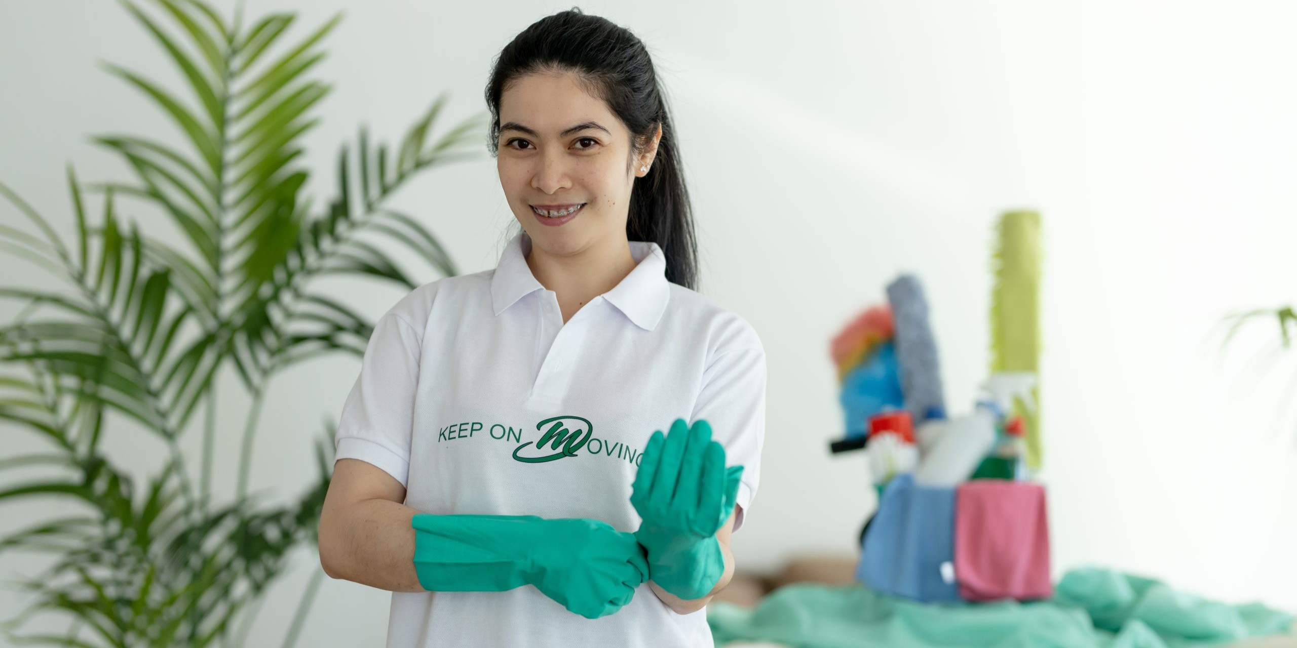 Mik Oy professional cleaner putting on gloves in Vantaa, expert office and home cleaning services across Helsinki, Espoo and Uusimaa