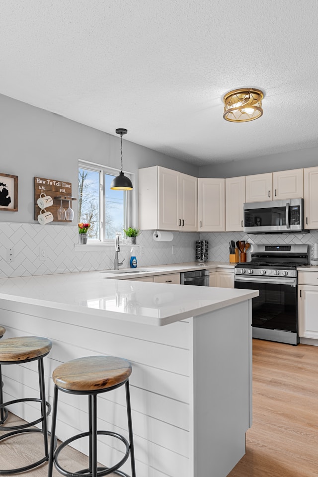 Spotless AirBnB rental kitchen with white cabinets, stainless steel appliances, and clean countertops after a Mik Oy turnover cleaning in Helsinki, Finland